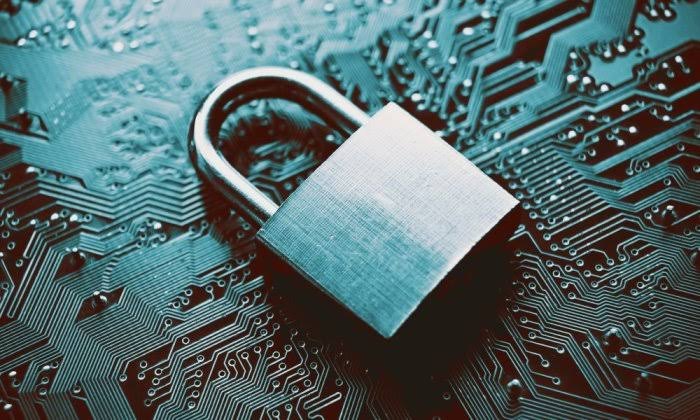 A metal padlock resting on a circuit board